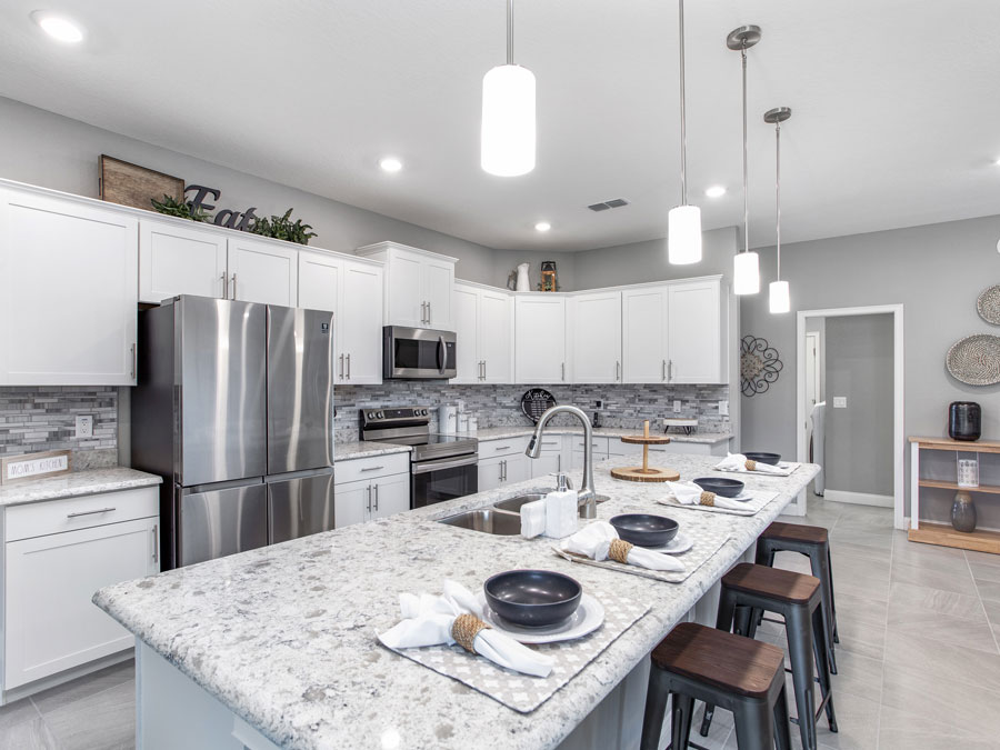Waylyn model home kitchen features tile backsplash
