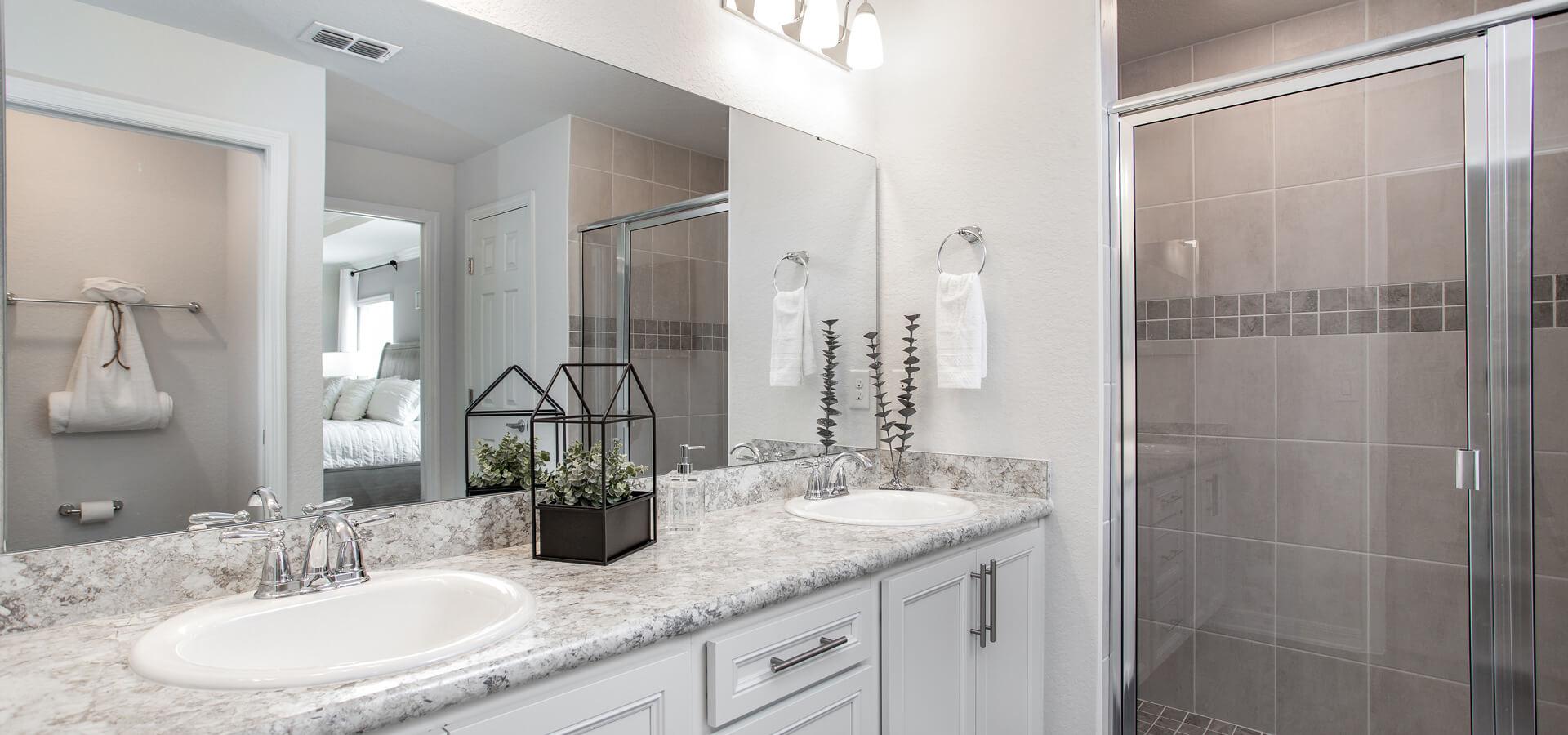En-suite bathroom with dual vanity and tiled shower