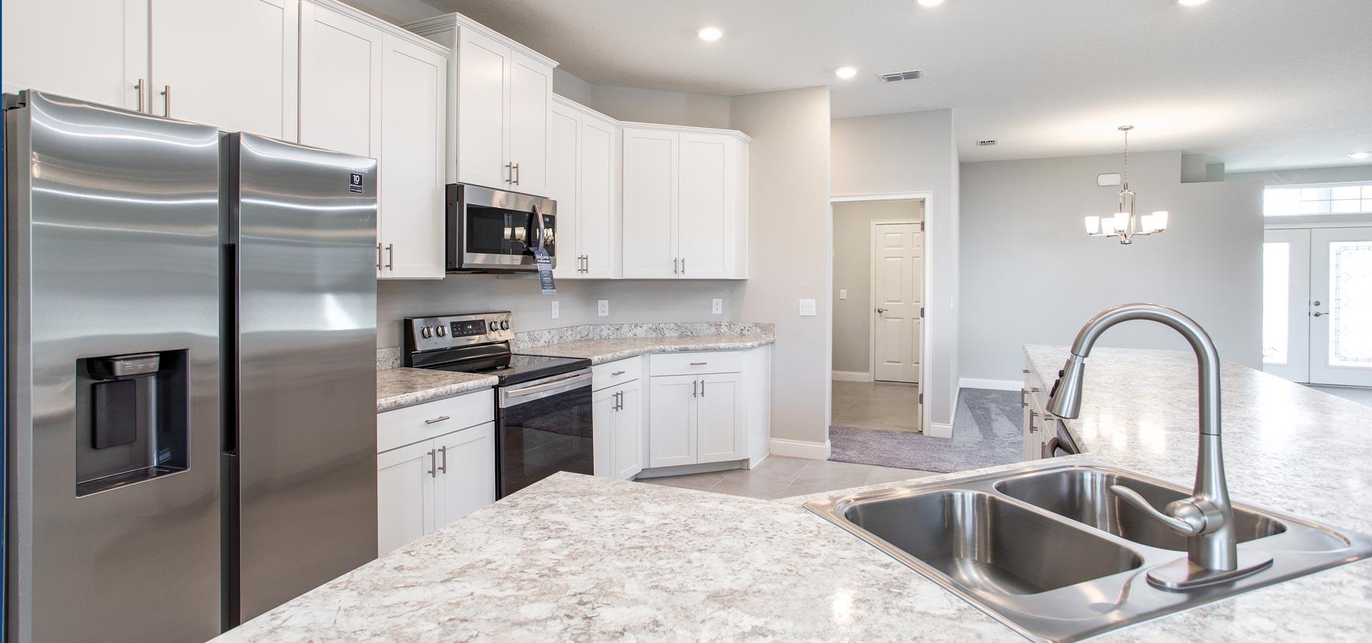 The kitchen in the open layout Windemere floor plan, a new construction home in Winter Haven at Chestnut Creek