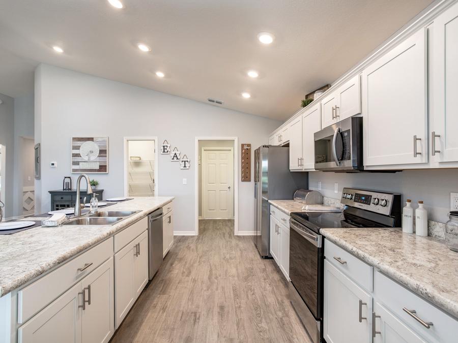 Open kitchen with island and walk-in pantry - VillaMar in Winter Haven, FL